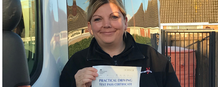 D1 driver training candidates shows her pass certificate