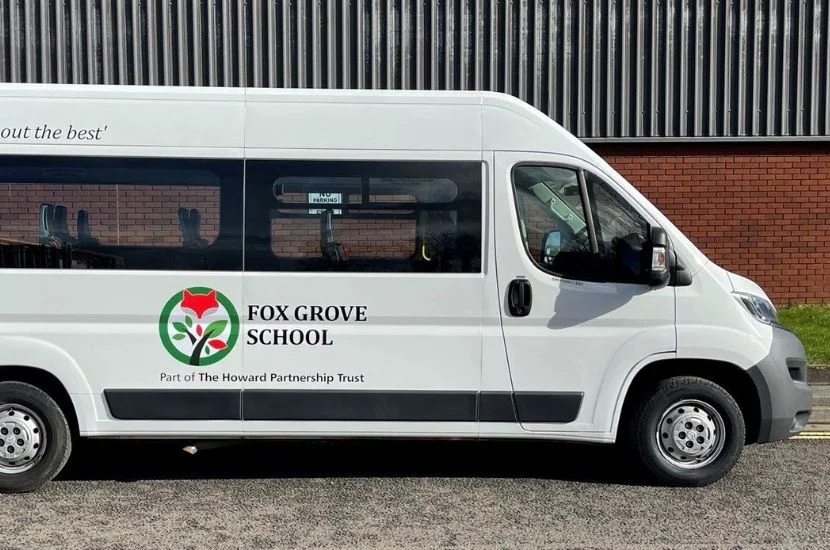 Standard logo and livery on white minibus for Foxgrove School